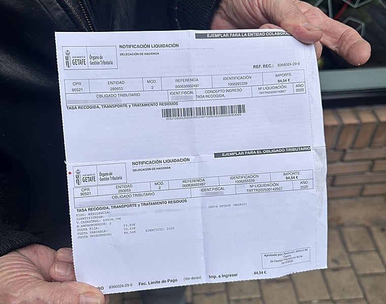 Herminio shows garbage fee receipt, with expired barcode