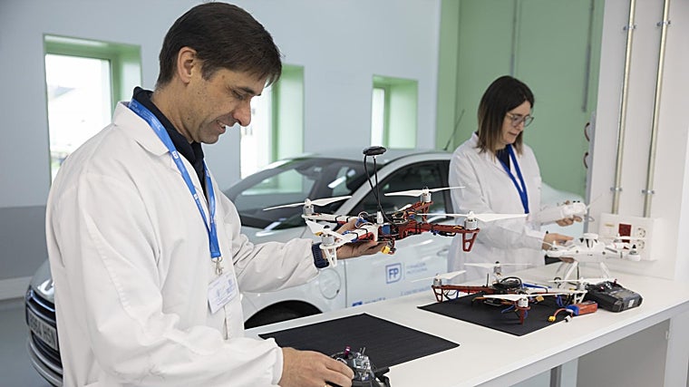 In the background, the electric vehicle prototype which integrates new ways of producing green energy