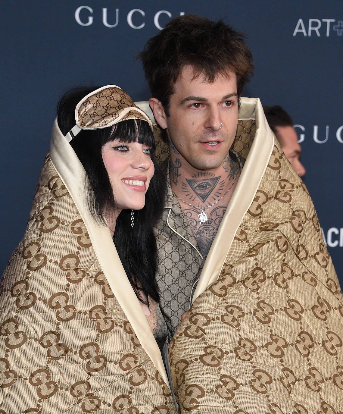 Billie Eilish y su novio, Jesse Rutherford, posaron en la alfombra roja envueltos en una manta de Gucci, debajo,  llevaban pijamas de la firma. 
