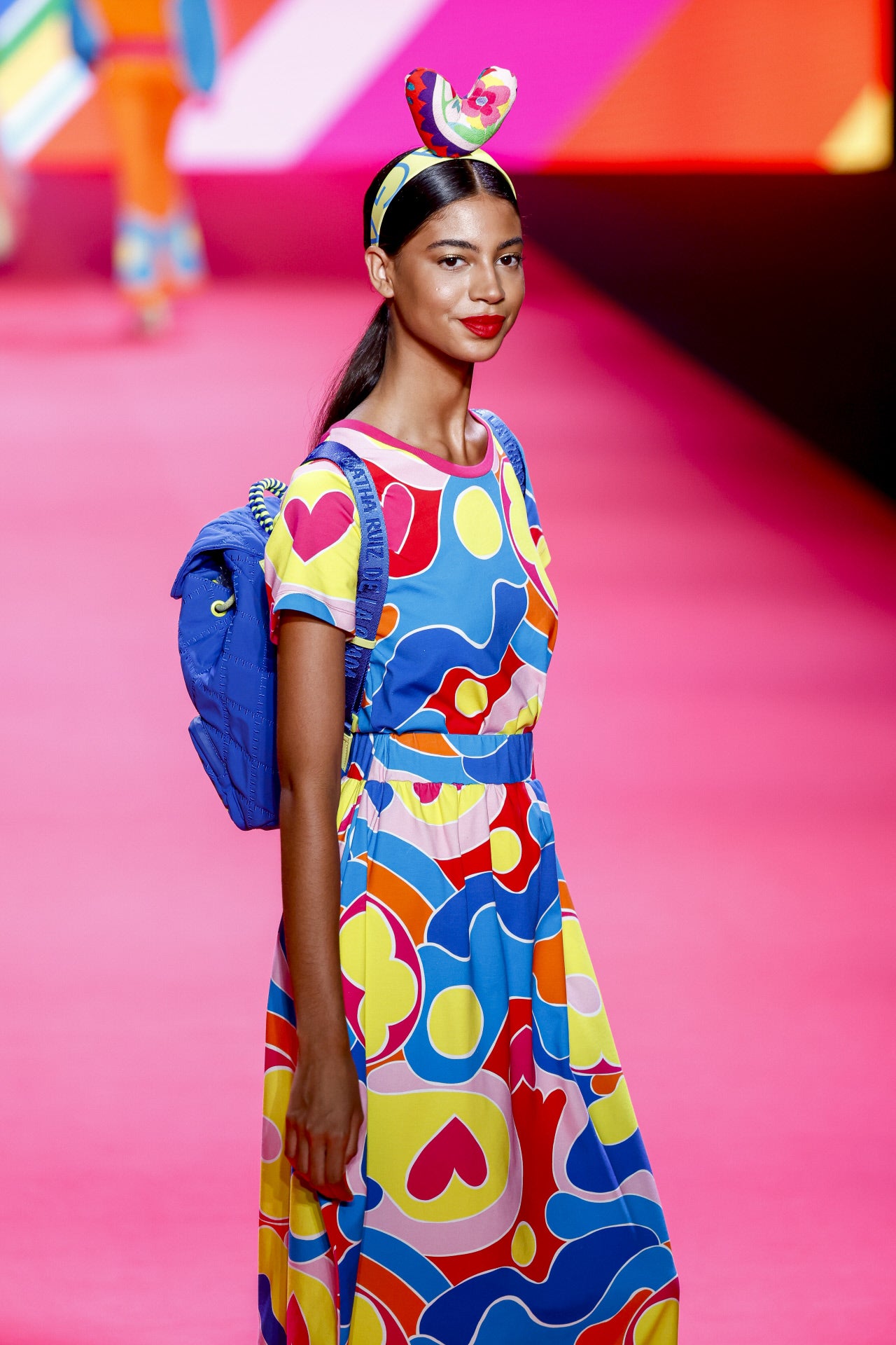 Desfile de Ágatha Ruiz de la Prada en la MBFWMadrid primavera-verano 2024. Su propuesta para el próximo año incluye conjuntos con faldas largas cargadas de estampados característicos de la firma: corazones, círculos y flores. Además, ha incluido una colección de mochilas y diademas.