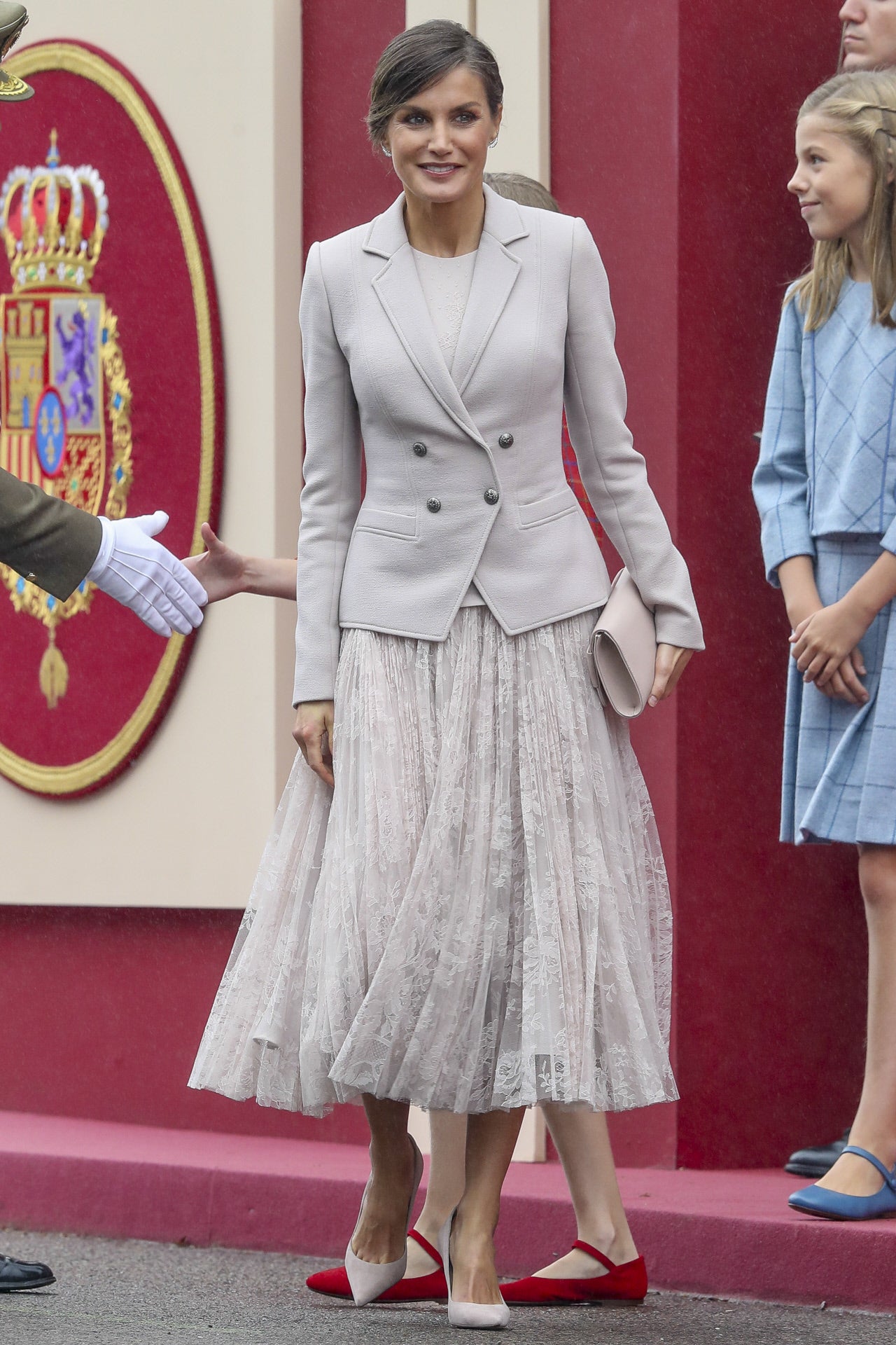 Doña Letizia en 2018, apostó por un atuendo también de su diseñador español favorito Felipe Varela. En un color grisáceo, el vestido estaba compuesto por una falda vaporosa floral y una americana abrochada. 