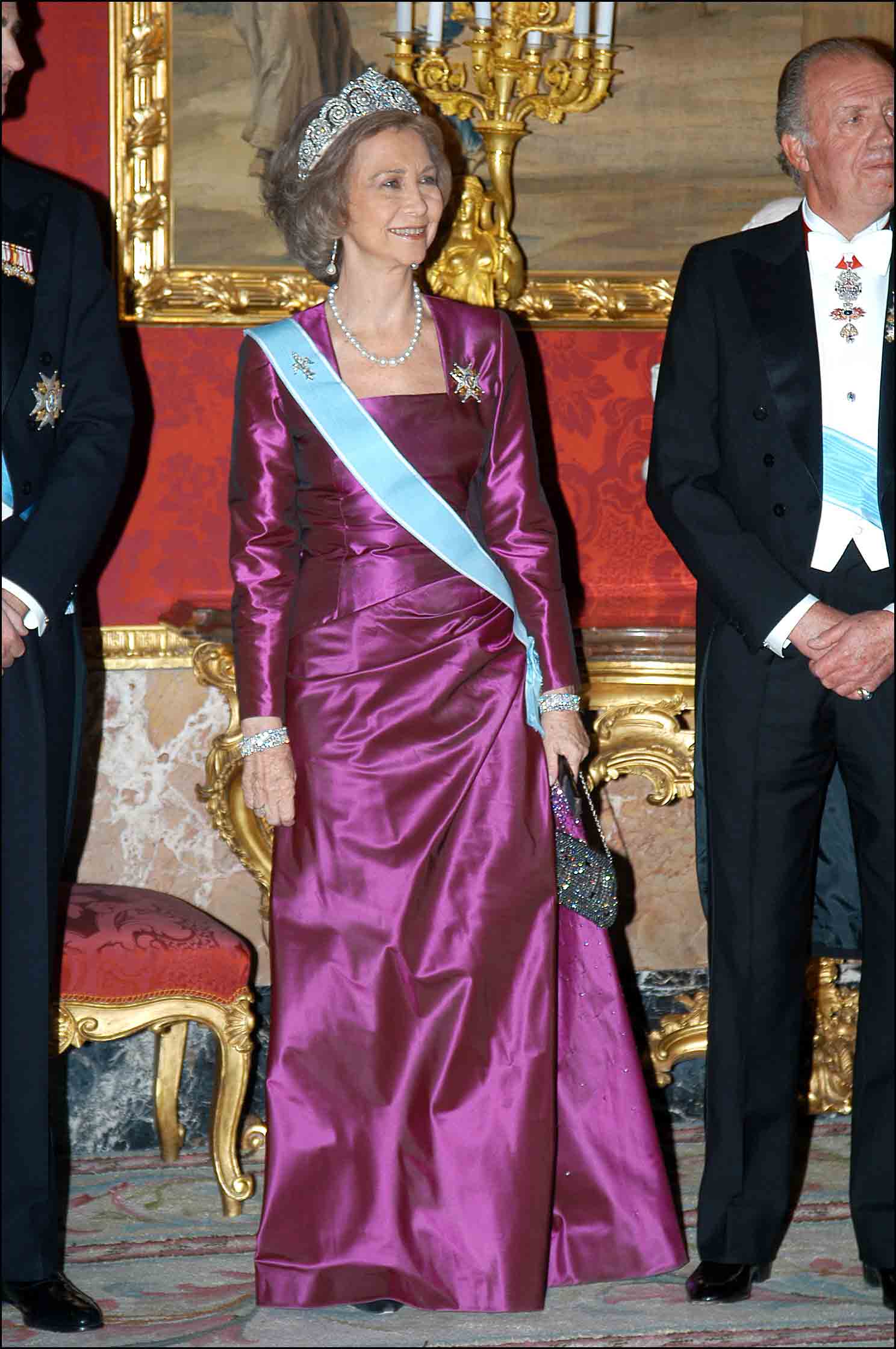 Doña Sofía, con un vestido morado, largo y con escote cuadrado.