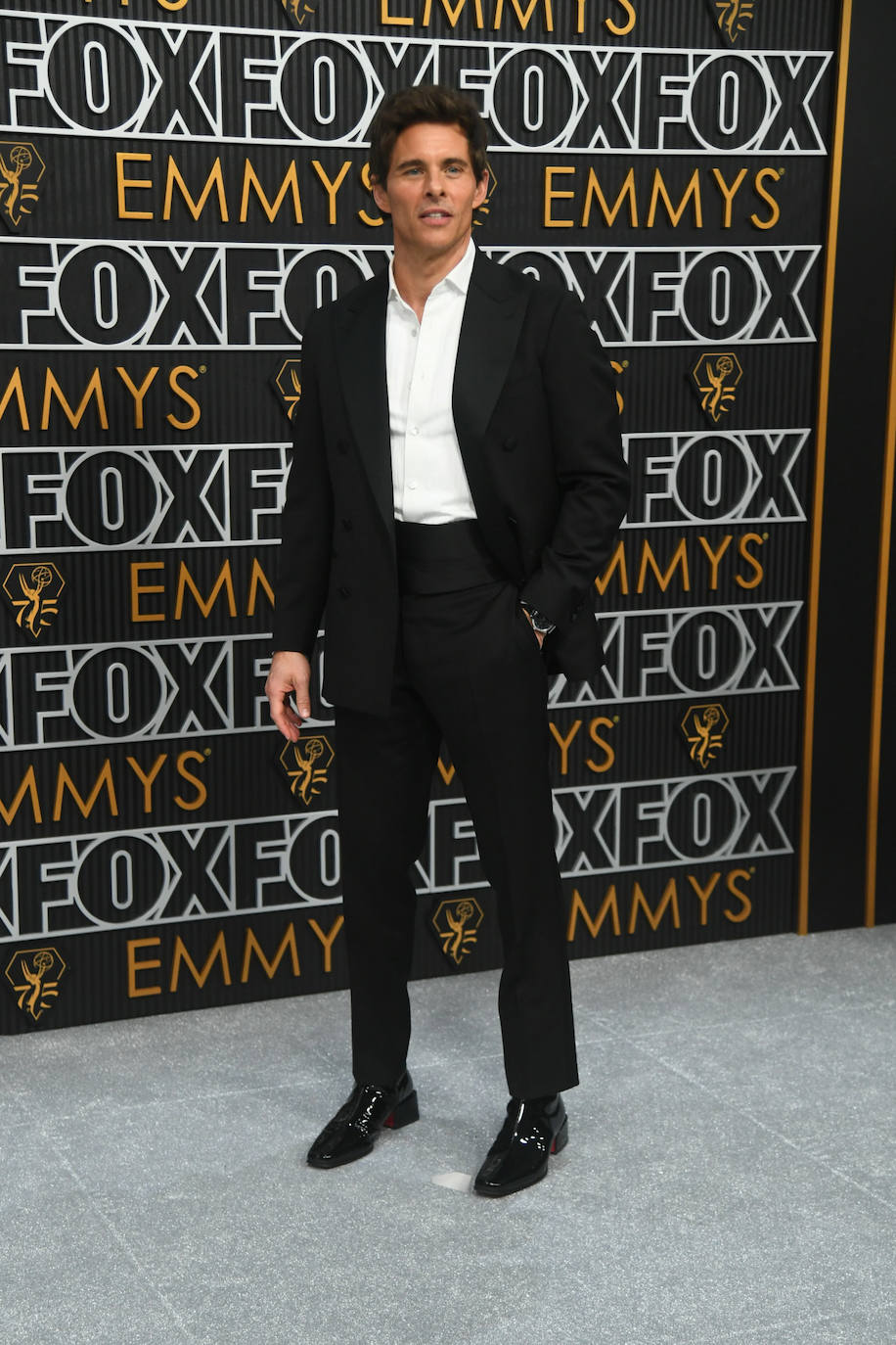 James Marsden con traje negro y camisa blanca, no llevó corbata ni pajarita. 