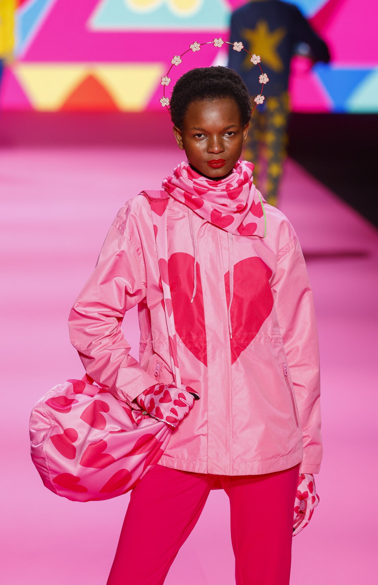 MBFWMadrid: Ágatha Ruiz de la Prada (Otoño/Invierno 2024-2025). El casco, una bola casi perfecta que se mueve por toda la ciudad sobre la cabeza de diversos motoristas, es el vehículo ideal para nuestros diseños alegremente irreverentes (o irreverentemente alegres) convirtiéndolos en objetos de arte Pop con ambiciones más elevadas que simplemente proteger contra.