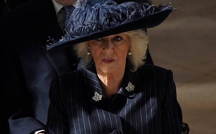 Imagen principal - La Reina Camilia con gran sombrero y traje de raya diplomática; la Familia Real griega con Ana María, que eligió abrigo de raya diplomático, Marie-Chantal con vestido en color burdeos, y Alexia de Grecia con abrigo gris y flor blanca; y las infantas Cristina y Elena. 