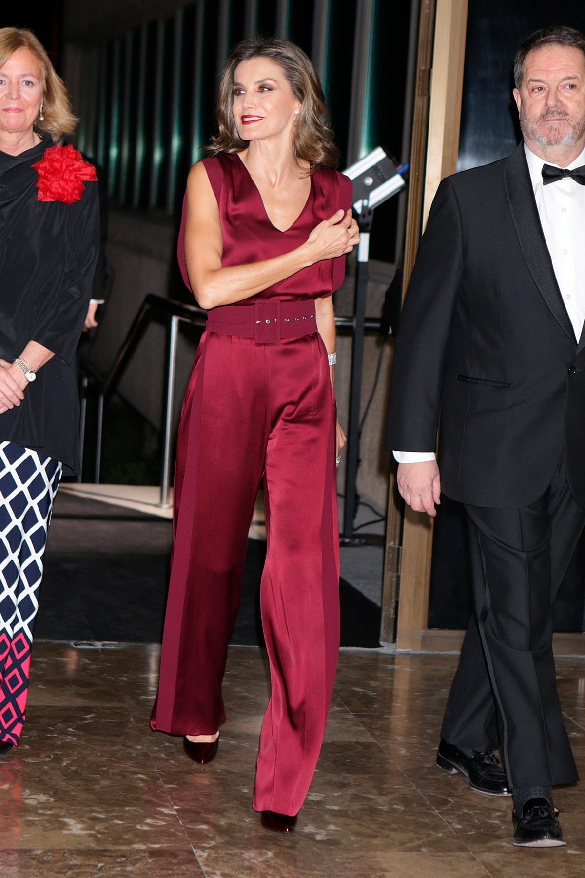 En 2017, Doña Letizia dejó los vestidos y se decantó por un mono granate satinado sin mangas y con un gran cinturón de Ángel Schlesser. Lo más llamativo de su look, su maquillaje. 