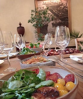 Imagen secundaria 2 - Arriba, Javier Brichetto, maestro parrillero de Piantao, durante el ritual de un asado argentino. Sobre estas líneas, uno de los cortes premium que la empresa Pampeana exporta a España desde la Pampa argentina. A la derecha, alguno de los acompañamientos de un asado tradicional en la residencia de Ricardo Alfonsín