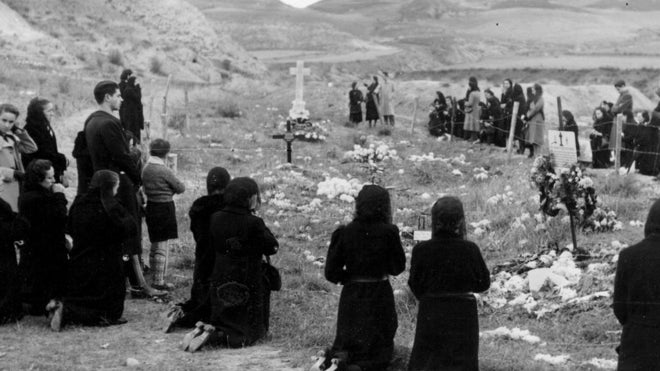 Familiares de las víctimas de los fusilamientos rezan junto a las fosas en noviembre de 1939
