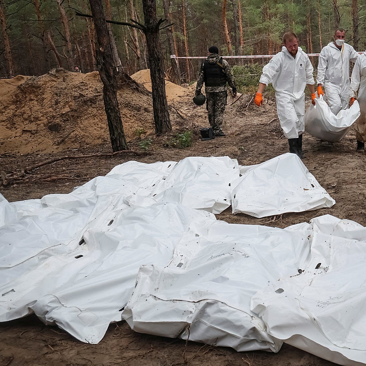 Cadáveres maniatados y con sogas en el cuello en una fosa común en Izium