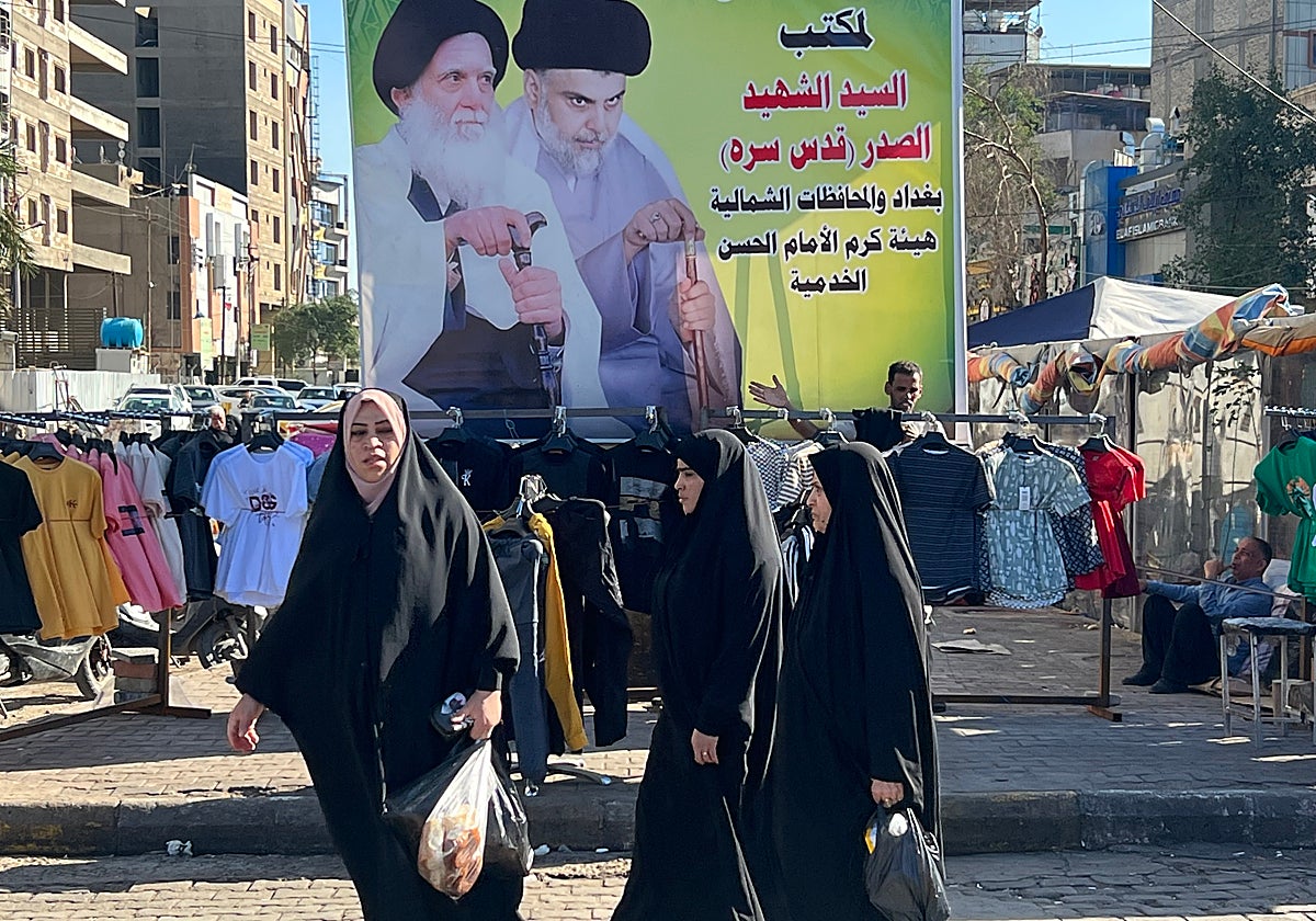 Jóvenes iraquíes caminan por las calles de Bagdad