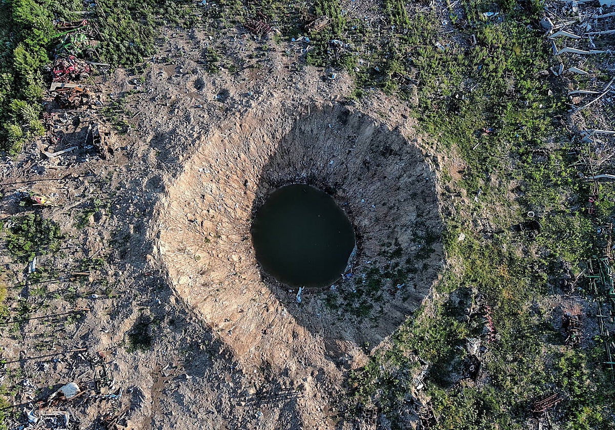 Una fotografía tomada con un dron muestra un gran cráter de bombardeo en un pueblo de Járkov, Ucrania
