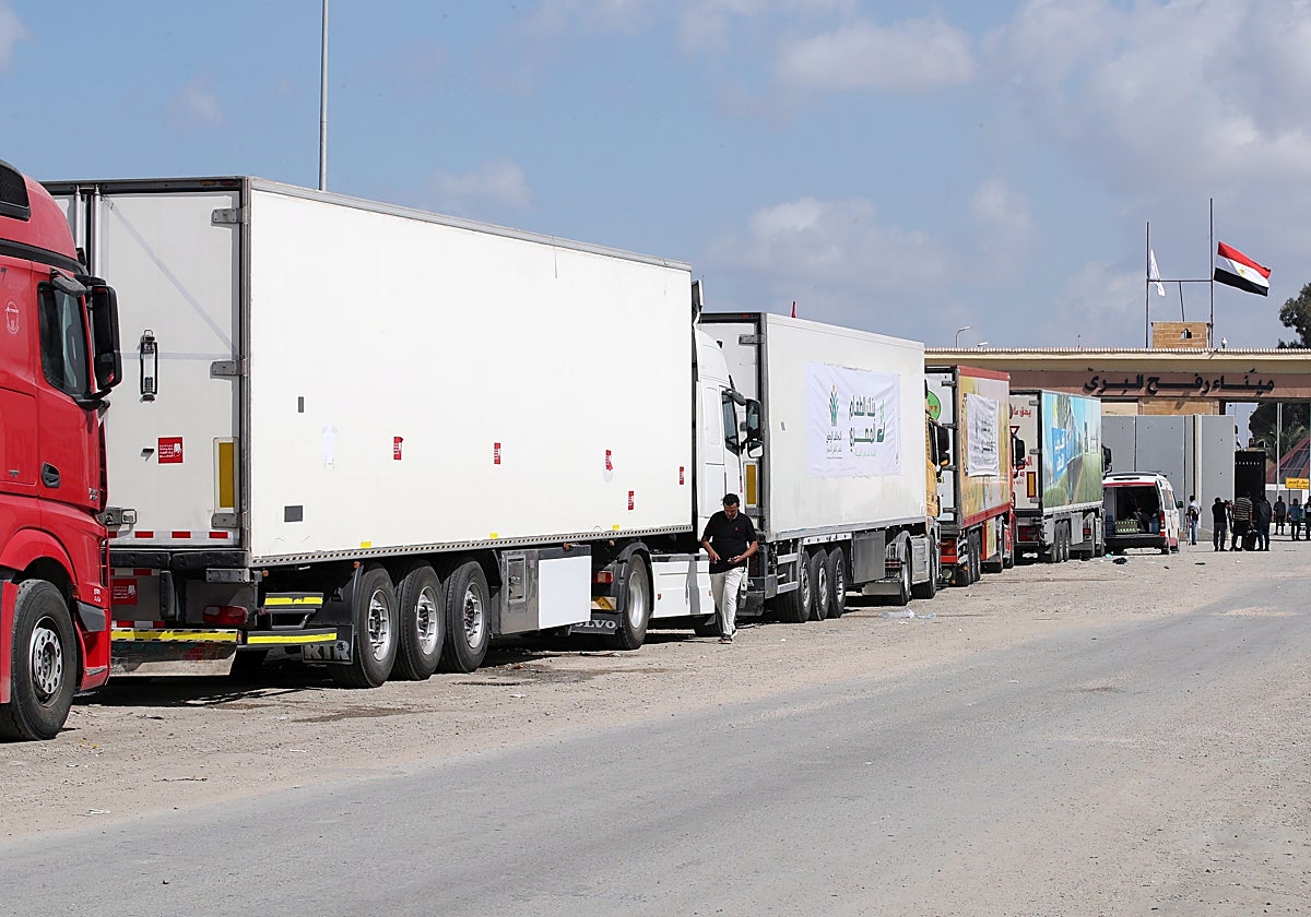 Camiones de un convoy de ayuda humanitaria aparcados frente a la frontera entre Egipto y Gaza, en Rafah