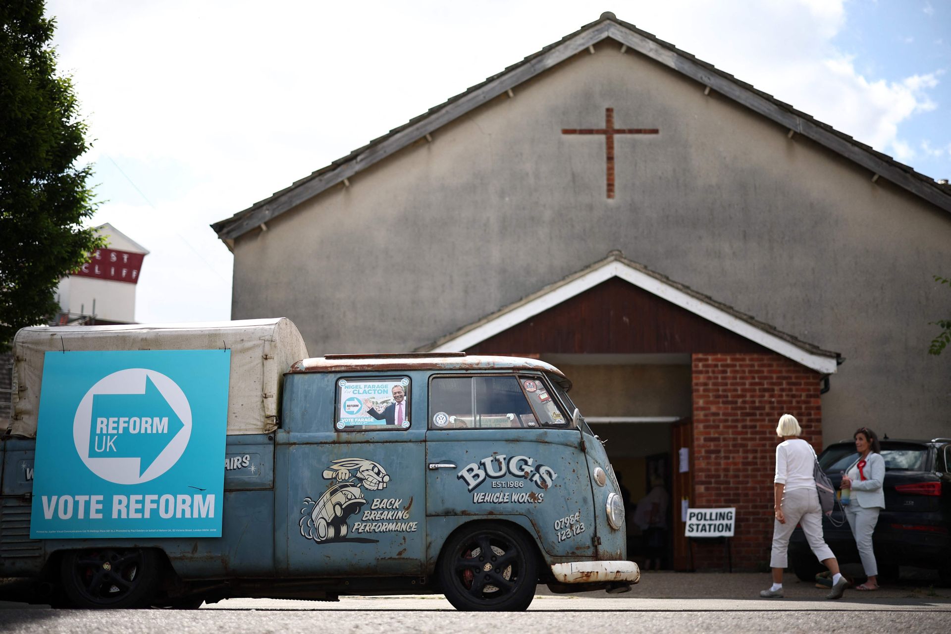 Caravana del Partido Reformista aparcada en frente de un centro electoral.