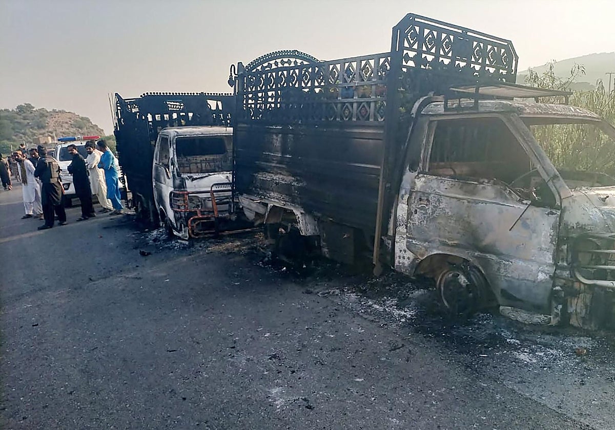 Vehículos calcinados próximos al lugar del tiroteo en una carretera nacional en Baluchistán, Pakistán