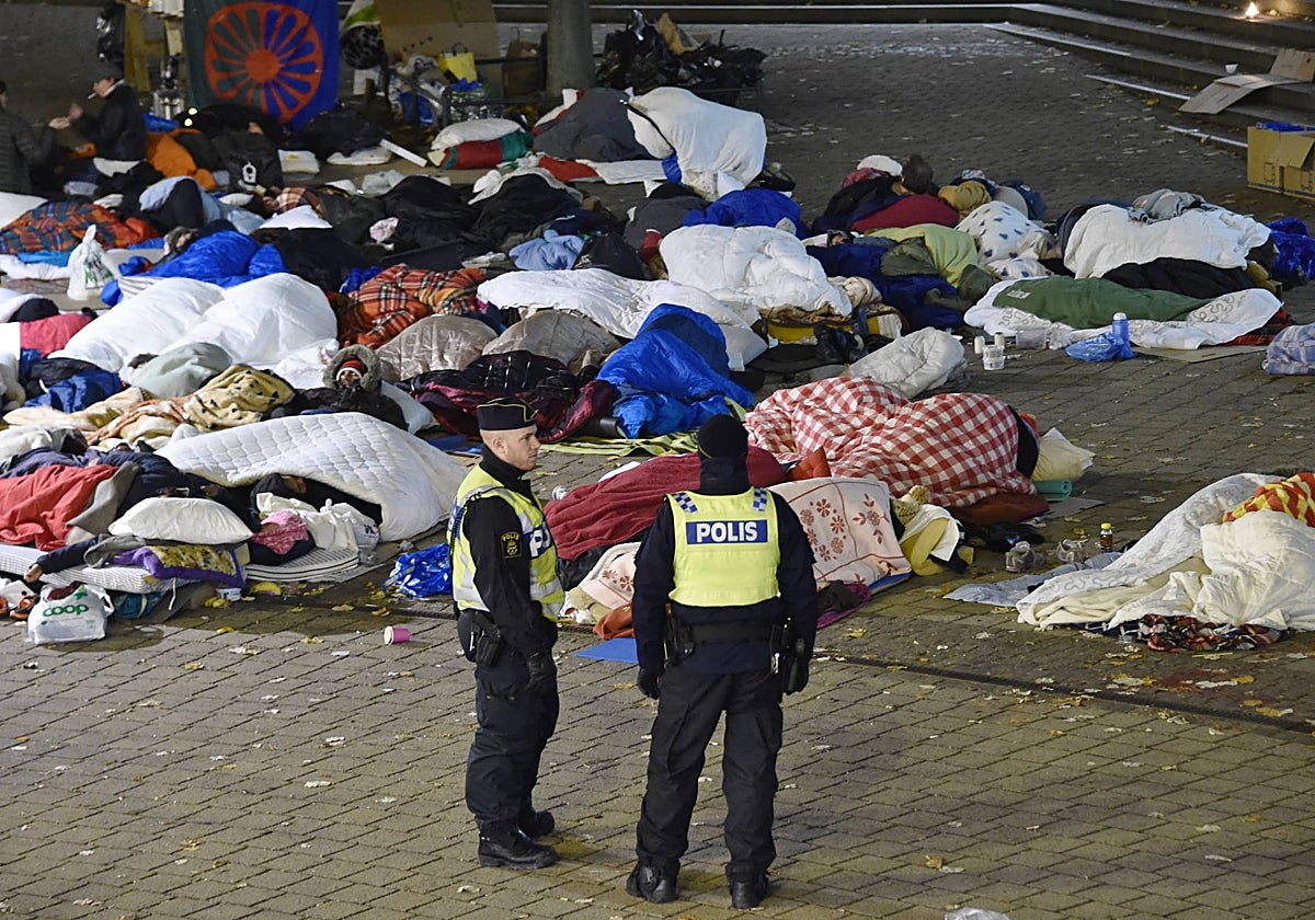 Una pareja de policías vigila en Malmo un campamento de inmigrantes