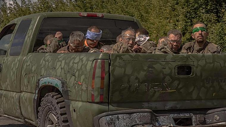 Un vehículo militar ucraniano transportando a milicianos rusos capturados con los ojos vendados
