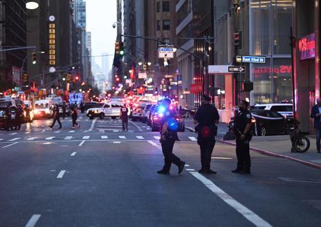 Imagen secundaria 1 - La primera foto muestra un agente de Policía acordonando la zona, en la de la izquierda se ve a los agentes cerrando la calle y en la imagen de la derecha se observa el lugar de los hechos, el edificio número 345 Park de Avenue
