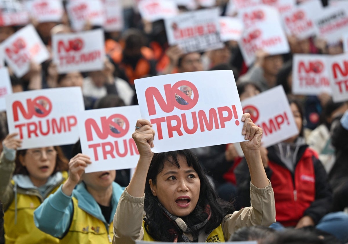 Manifestantes sostienen carteles con :«¡No a Trump !» durante una protesta en Seúl