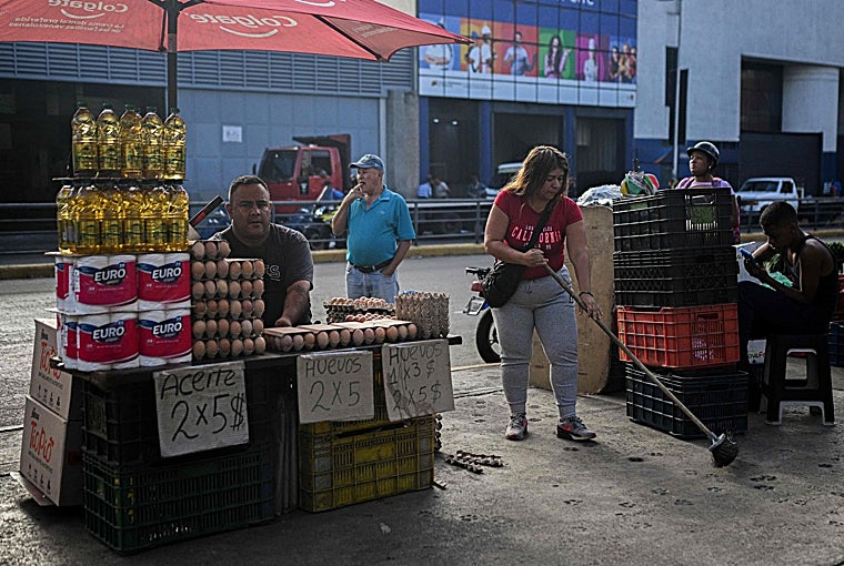 A man sells oil, eggs and toilet paper on the street in front of Carcassia's important market