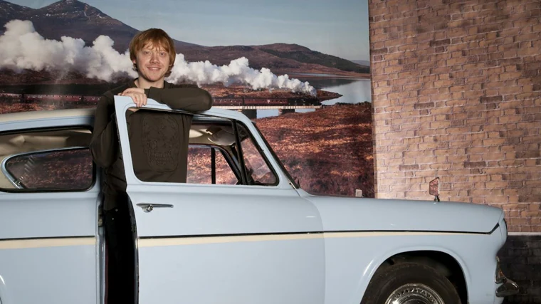 The actor Rupert Grind, Ron Weasley in the film, next to one of the Anglia used in the filming