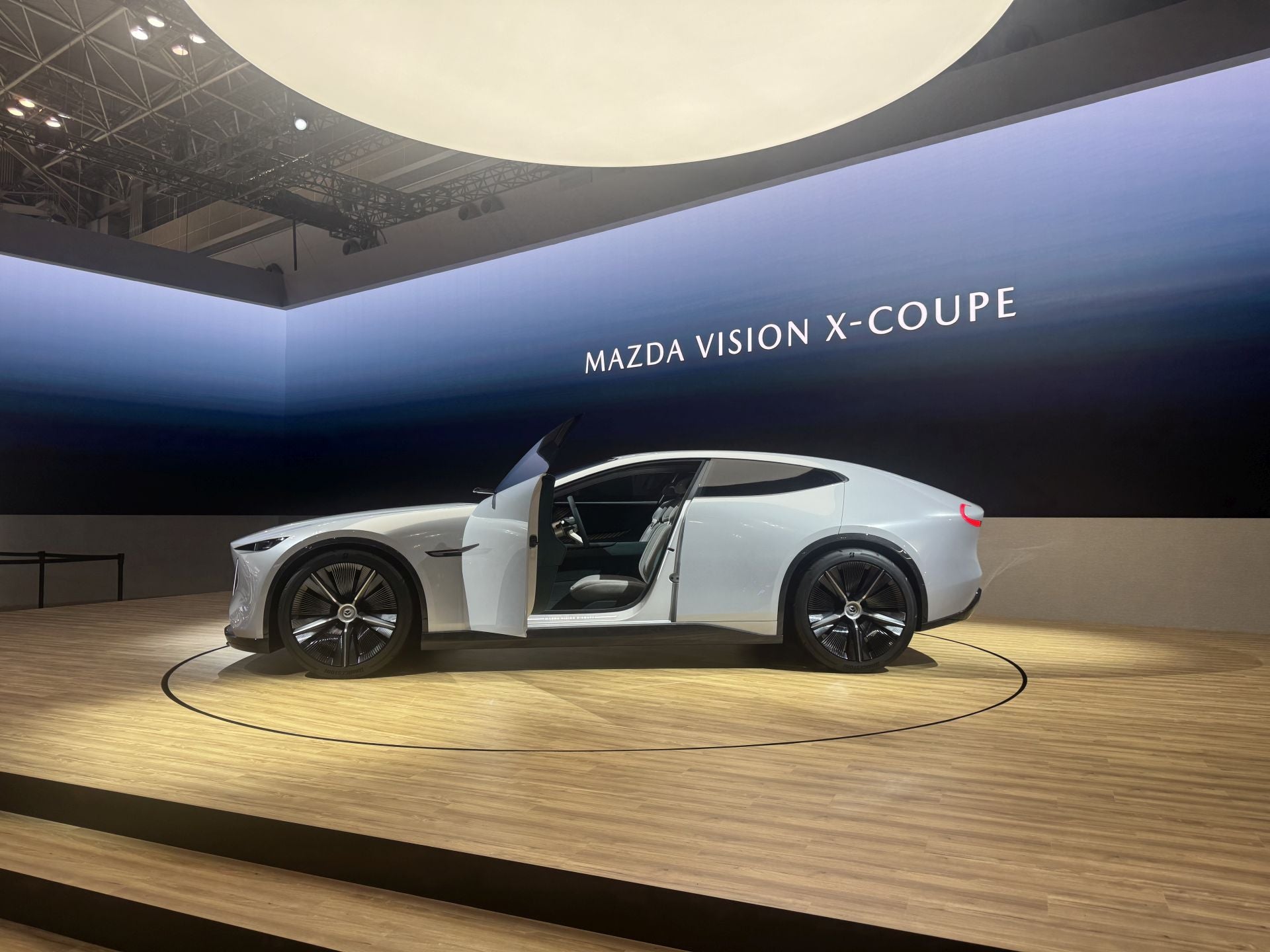 Mazda, la marca de Hiroshima muestra una estrategia dual: preservar la esencia de la conducción («joy of driving») mientras avanza hacia la sostenibilidad. Entre las novedades desvelan dos modelos conceptuales bajo la denominación Mazda Vision‑X Coupe y Mazda Vision‑X Compact. El primero es un crossover coupé plug-in-híbrido que desarrolla aproximadamente 503 bhp, con autonomía eléctrica estimada en 160 km y alcance combinado de unos 800 km. El segundo, más pequeño, está orientado a la interacción humano-vehículo mediante inteligencia artificial empática («empathetic AI») y propicia una nueva relación entre coche y conductor. También muestran el nuevo Mazda CX‑5 (especificación europea) por primera vez en Japón, junto con tecnología de captura de CO₂ y combustibles neutros derivados de algas, como parte de su visión a 2035.