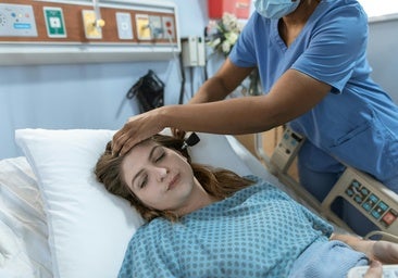 Una mujer en el hospital atendida por una profesional sanitaria