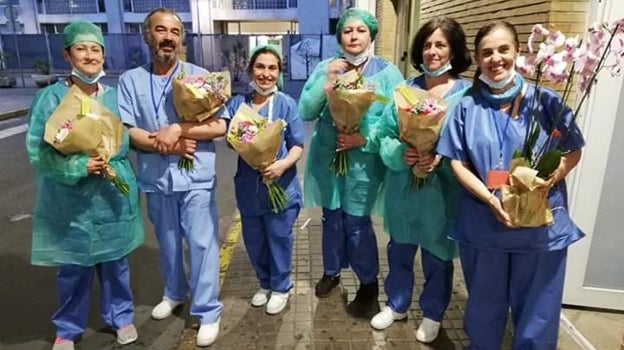 Celadores del Virgen del Rocío con los ramos de flores de agradecimiento que recibieron de los sevillanos por su labor durante la pirmera ola de la pandemia