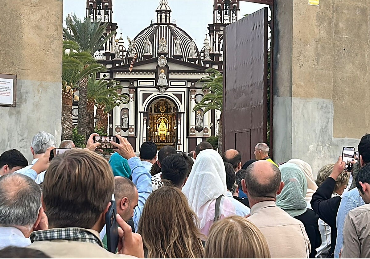 Un grupo de persona se agolpa a las puertas de la iglesia del Palmar de Troya para entrar