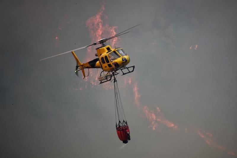 Vierten grandes cantidades de agua desde el aire sobre las llamas para sofocarlas