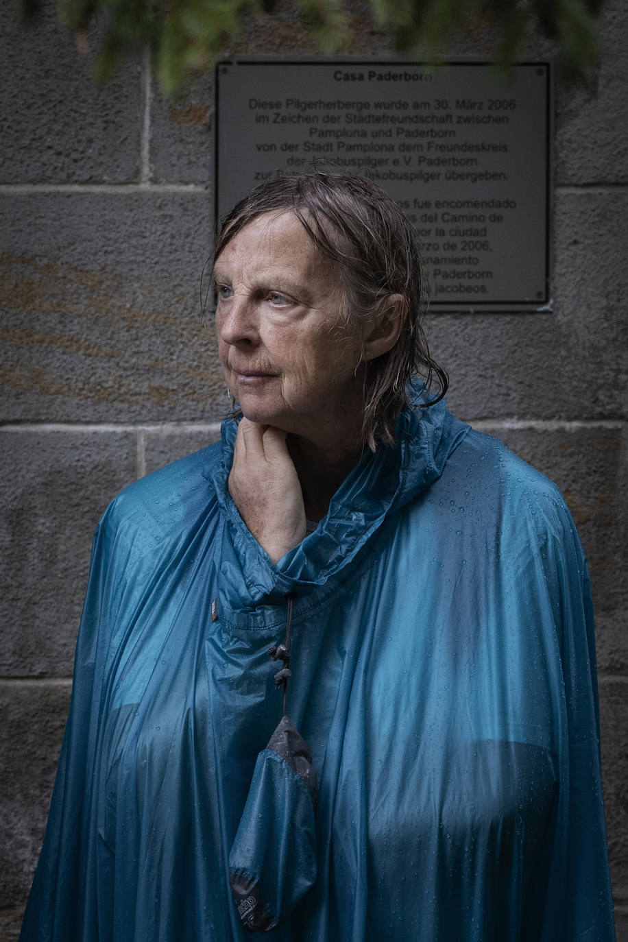 Una peregrina francesa que realiza el Camino de Santiago espera este sábado la apertura de uno de los albergues de Pamplona para protegerse de la intensa lluvia