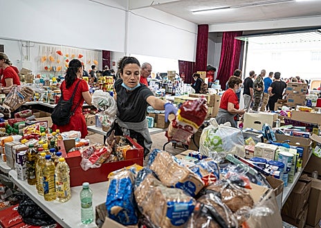 Imagen secundaria 1 - Arriba, el estado actual del barranco. Abajo, redes de ayuda en la casa de Andalucía (izquierda) y voluntarias limpiando (derecha)