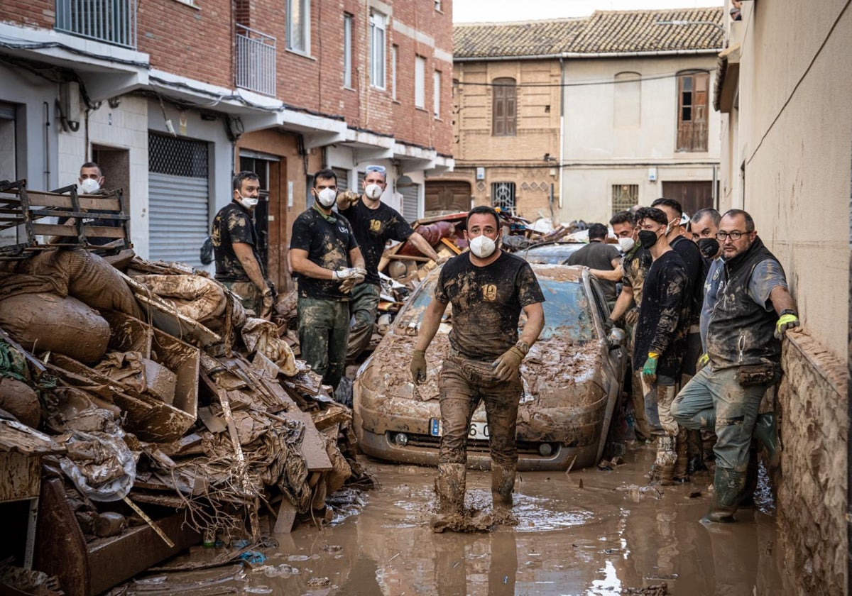 Agentes de la Policía catalana y vasca, como voluntarios durante las tareas de ayuda a los afectados por la DANA en Catarroja