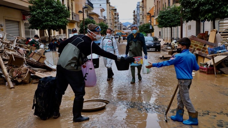 Adrià De la Torre Fontanet, de nueve años, limpiaba el barro frente a su casa en Algemesí cuando un voluntario, conmovido, le entregó una caja de galletas