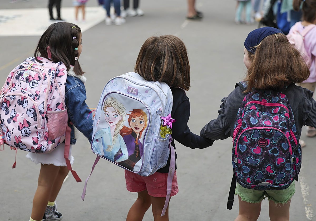 Unas niñas entran juntas en un colegio