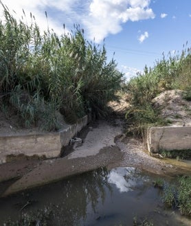 Imagen secundaria 2 - Su particular orografía hace que el Poyo se estreche aguas abajo, cuando el terreno se hace más llano.. En la imagen superior, el giro de 90 grados que el Poyo hace apenas un kilómetro después de donde se encuentra el caudalímetro. Además del imposible giro para el agua,el cauce es mucho más reducido que aguas arriba. En la segunda foto, las obras de reconstrucción del puente sobre el bypass que derribó el barranco del Gallego. Se puede observar la anchura del barranco en ese punto, cuando unos metros más abajo (en la tercera foto), su desembocadura en el cauce principal del Poyo tiene apenas un mar de metros. Esos estrechamientos provocaron que el 29-O toda los campos y los polígonos alrededor se inundaran.