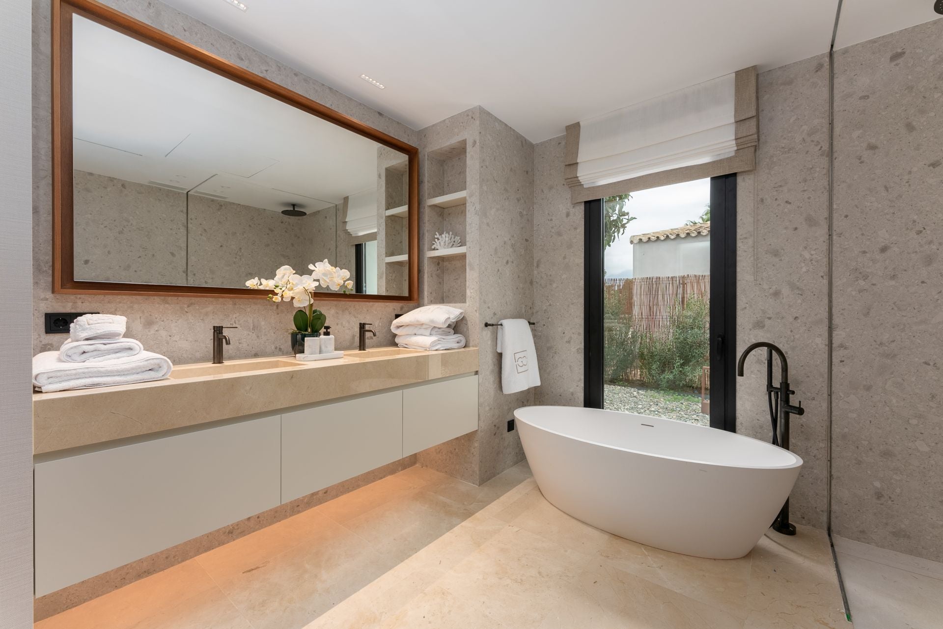 Uno de los baños con tocador doble y bañera vista, funcionalidad y estilo en un mismo espacio. 