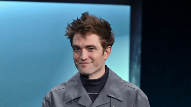 Image after - Robert Pattinson shaved and with a messy fade cut.