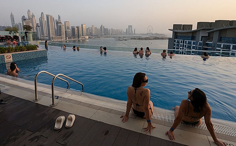 Imagen principal - En la foto superior, la piscina infinita del NH Collection Dubai The Palm. Sobre estas líneas, la zona de tiendas de oro en el zoco, la zona antigua de la ciudad. A la derecha, una de las dos tiendas de Manolo Blahnik que hay en el Dubai Mall. 