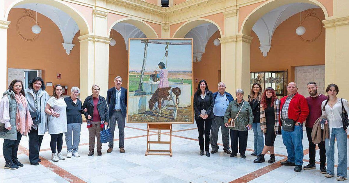 El cuadro rodeado de responsables de la universidad y familiares del artista