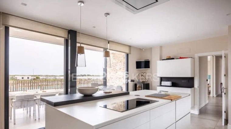 Las ventanas de la cocina están orientadas tanto a la fachada principal como hacia la piscina, dándole luminosidad
