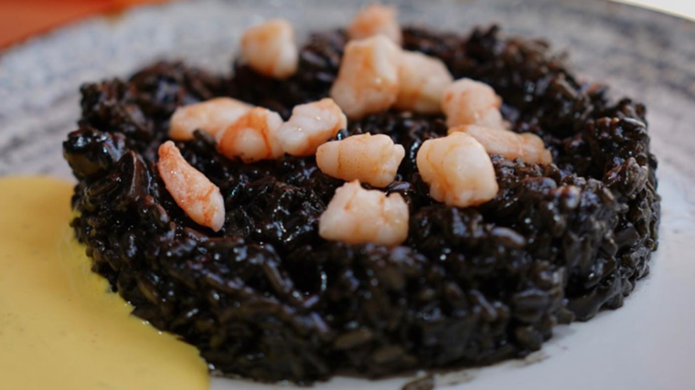 Plato de arroz negro servido en el Restaurante La Patera