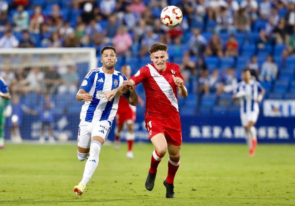 Caye Quintana pugna por un balón con un jugador del Sevilla Atlético