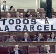 Mientras se llamaba a la votación, los parlamentarios de IU desplegaron una pancarta con el lema