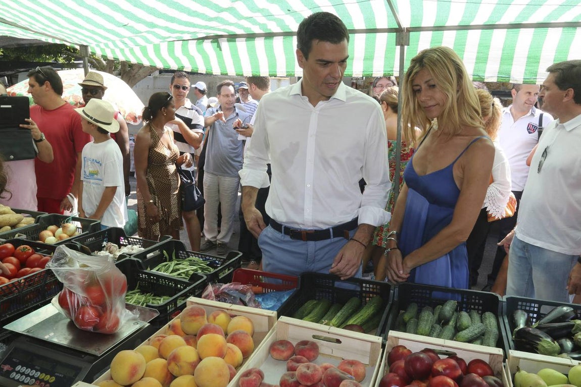 El secretario general del PSOE, Pedro Sánchez, acompañado de su esposa, Begoña Fernández, compra en un mercadillo de la localidad almeriense de Mojácar donde pasa unos días de vacaciones