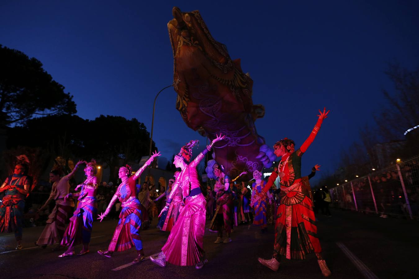 10. Bailarinas de Sueños de India seguidas del dragón Patacas, durante la cabalgata de los Reyes Magos que ha recorrido hoy el paseo de la Castellana de Madrid