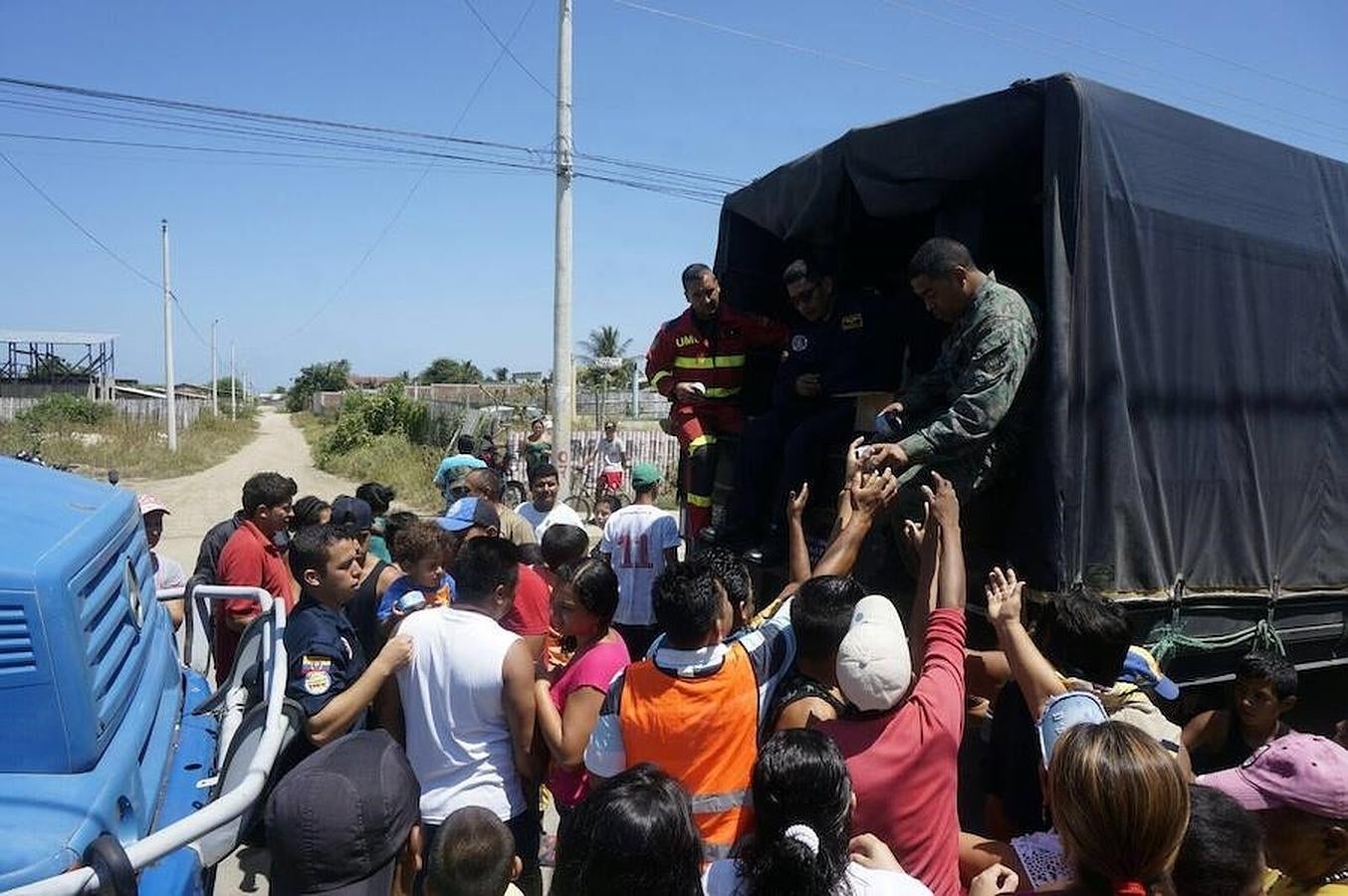 Uno de los grandes problemas a los que se enfrenta la población es la escasez de agua y de alimentos al haber sido destruidos los accesos y los puentes por el terremoto. En la imagen, el grupo de Ericam da agua y alimentos a algunos ecuatorianos