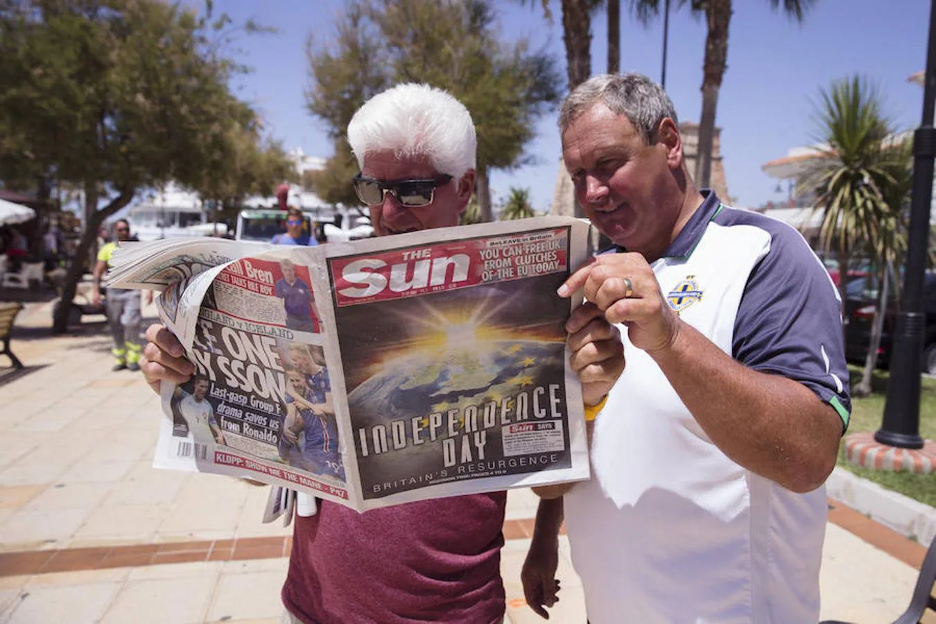 Dos británicos observan en Mijas Costa (Málaga) la portada del periódico The Sun, que abre su edición con una llamada al Brexit: «El día de la independencia»
