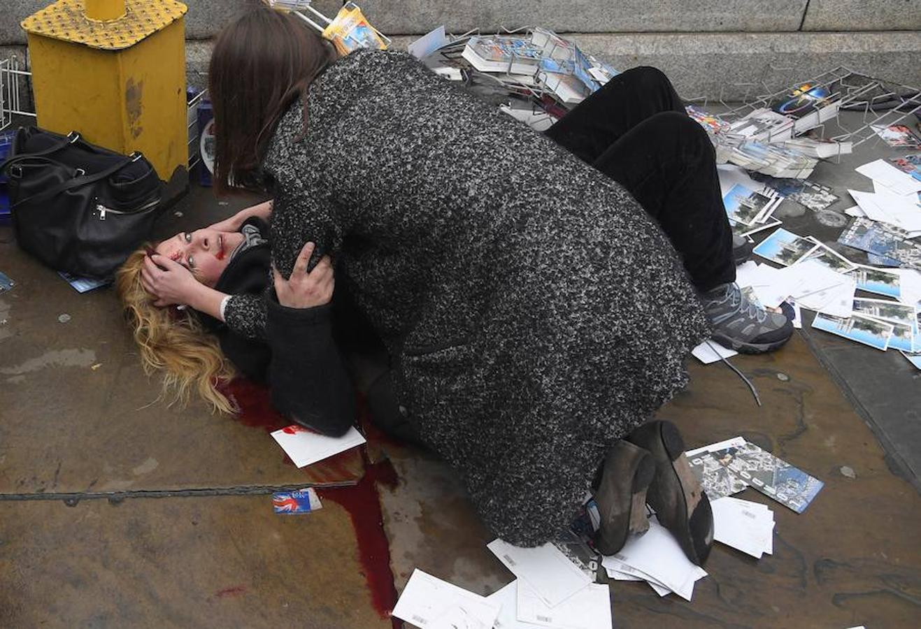 La obra del fotógrafo británico Toby Melville para Reuters tomada el 22 de marzo de 2017 que muestra a una mujer mientras consuela a una víctima herida tendida en el suelo tras ser atropellada por un automóvil conducido por el yihadista Khalid Masood, que causó la muerte de 5 personas, en el Puente de Westminister en Londres (Reino Unido). 