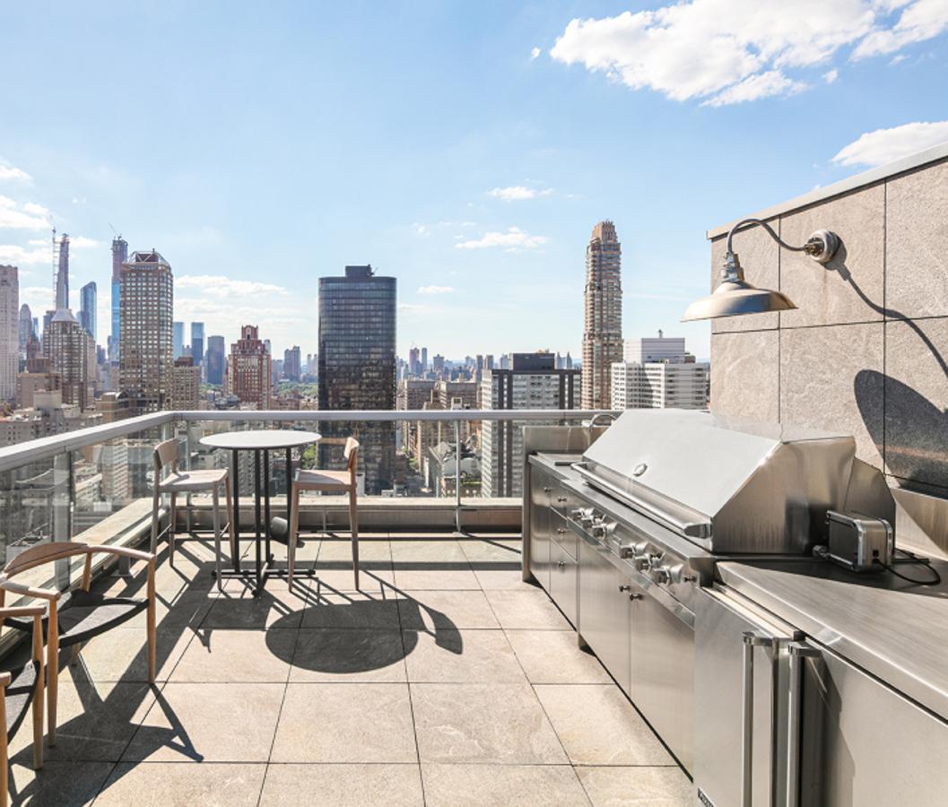 El espectacular ático de Jennifer Lawrence en Nueva York. En el segundo nivel del patio hay una cocina totalmente equipada con parrilla, fregadero y nevera, un espacio perfecto para preparar cenas con amigos en verano y disfrutar de las vistas. Incluye, también, mesas altas con taburetes para esperar mientras sale la comida.