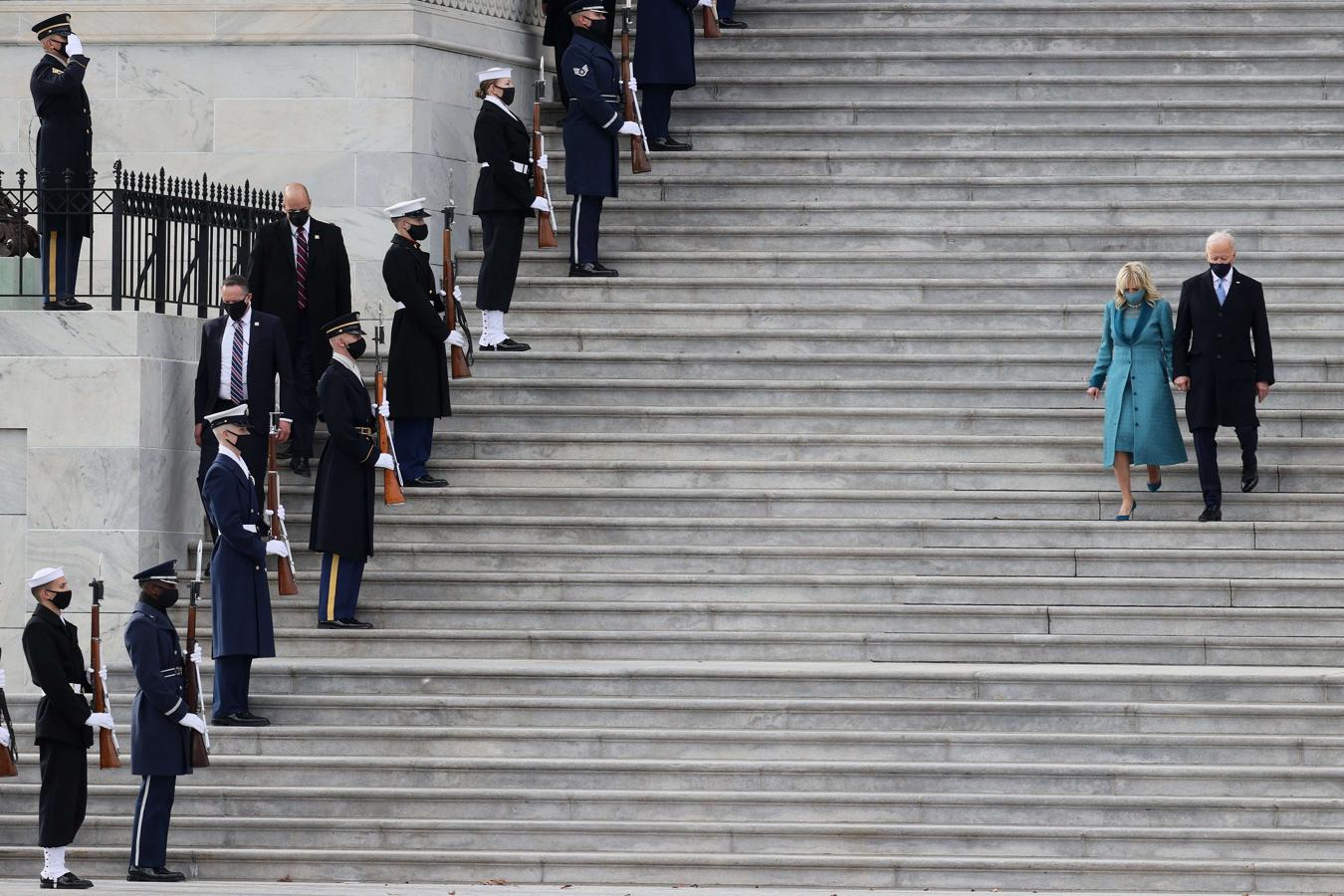 Los Biden descienden las escaleras del Capitolio. 